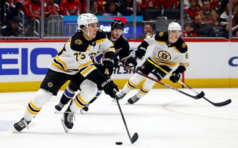Dec 31, 2024; Washington, District of Columbia, USA; Boston Bruins defenseman Charlie McAvoy (73) skates with the puck against Washington Capitals center Connor McMichael (24) at Capital One Arena. Mandatory Credit: Peter Casey-Imagn Images
