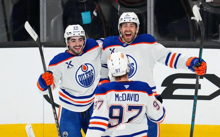 Mar 26, 2026; Las Vegas, Nevada, USA; Edmonton Oilers defenseman Evan Bouchard (2) celebrates with center Matt Savoie (22) and center Connor McDavid (97) after scoring a goal during an overtime period to give the Oilers a 4-3 victory over the Vegas Golden Knights at T-Mobile Arena. Mandatory Credit: Stephen R. Sylvanie-Imagn Images