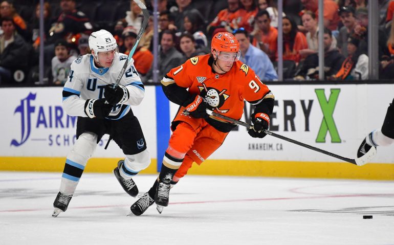 Sep 22, 2025; Anaheim, California, USA; Anaheim Ducks center Leo Carlsson (91) moves the puck ahead of Utah Mammoth center Cole Beaudoin (24) during the second period at Honda Center. Mandatory Credit: Gary A. Vasquez-Imagn Images