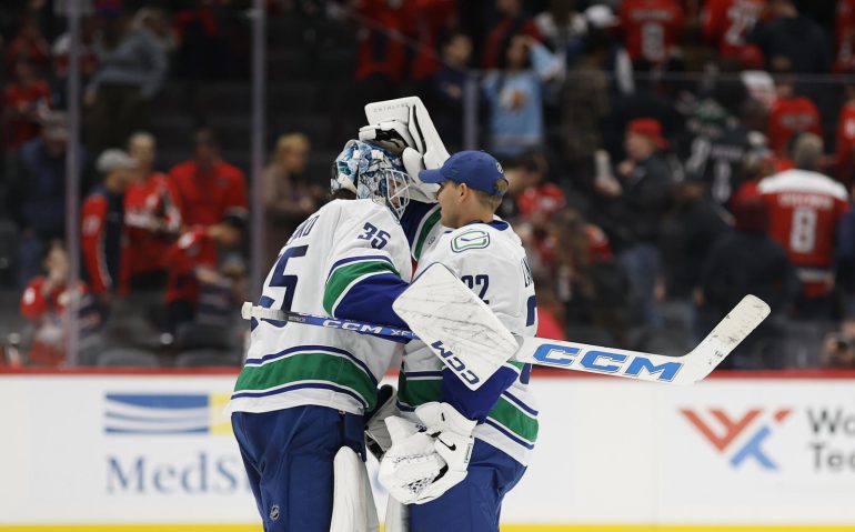 Oct 19, 2025; Washington, District of Columbia, USA; Vancouver Canucks goaltender Thatcher Demko (35) celebrates with Canucks goaltender Kevin Lankinen (32) after their game against the Washington Capitals at Capital One Arena. Mandatory Credit: Geoff Burke-Imagn Images