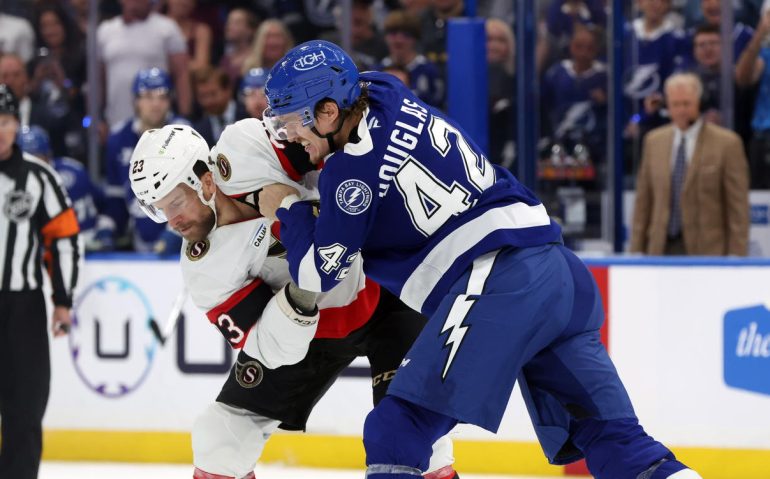 Oct 9, 2025; Tampa, Florida, USA;Tampa Bay Lightning defenseman Darren Raddysh (43) and Ottawa Senators left wing Kurtis MacDermid (23) fight during the first period at Benchmark International Arena. Mandatory Credit: Kim Klement Neitzel-Imagn Images