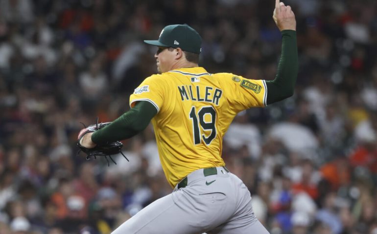 Jul 24, 2025; Houston, Texas, USA;  Athletics pitcher Mason Miller (19) delivers a pitch during the eighth inning against the Houston Astros at Daikin Park. Mandatory Credit: Troy Taormina-Imagn Images