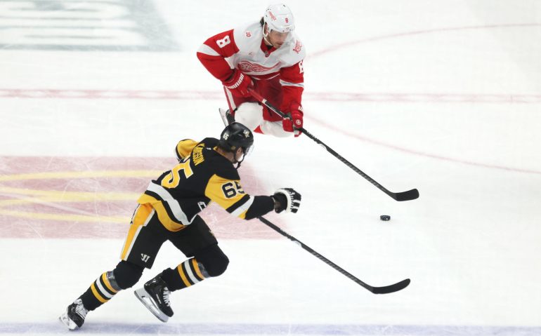 Mar 31, 2026; Pittsburgh, Pennsylvania, USA;  Detroit Red Wings defenseman Ben Chiarot (8) skates with the puck against Pittsburgh Penguins defenseman Erik Karlsson (65) during the third period at PPG Paints Arena. Mandatory Credit: Charles LeClaire-Imagn Images
