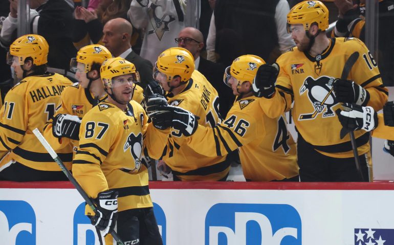 Oct 9, 2025; Pittsburgh, Pennsylvania, USA;  Pittsburgh Penguins center Sidney Crosby (87) celebrates his goal with the Penguins bench against the New York Islanders during the second period at PPG Paints Arena. Mandatory Credit: Charles LeClaire-Imagn Images