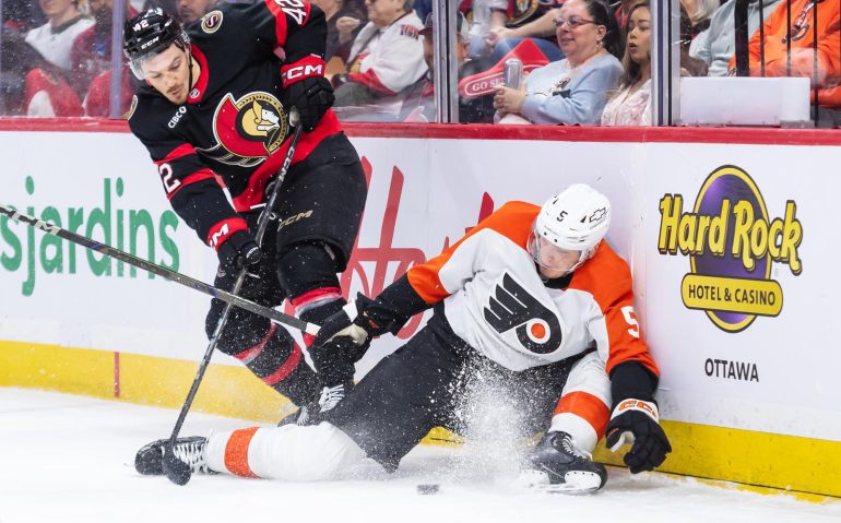 Apr 13, 2025; Ottawa, Ontario, CAN; Philadelphia Flyers defenseman Egor Zamula (5) is taken off the puck by Ottawa Senators right wing Hayden Hodgson (42) in the first period at the Canadian Tire Centre. Mandatory Credit: Marc DesRosiers-Imagn Images