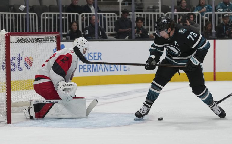 Oct 14, 2025; San Jose, California, USA;  Carolina Hurricanes goaltender Brandon Bussi (32) defends the goal during the third period against San Jose Sharks center Tyler Toffoli (73) at SAP Center at San Jose. Mandatory Credit: Stan Szeto-Imagn Images