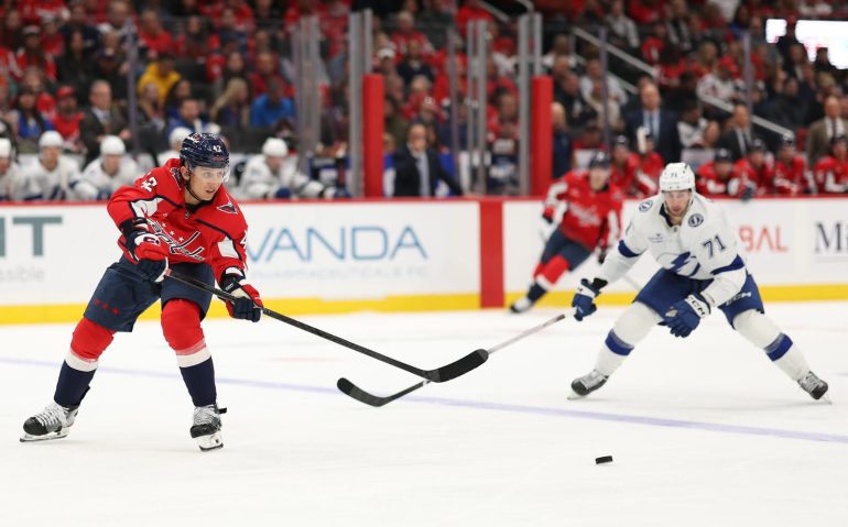Oct 14, 2025; Washington, District of Columbia, USA; Washington Capitals defenseman Martin Fehrvry (42) passes the puck as /Tampa Bay Lightning center Anthony Cirelli (71) defends in the second period at Capital One Arena. Mandatory Credit: Geoff Burke-Imagn Images
