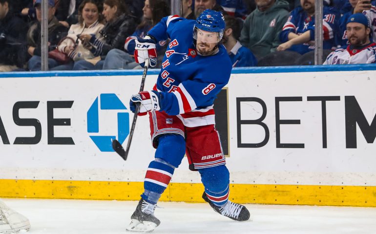 Mar 22, 2025; New York, New York, USA; New York Rangers center J.T. Miller (8) clears the puck against the Vancouver Canucks during the second period at Madison Square Garden. Mandatory Credit: Danny Wild-Imagn Images
